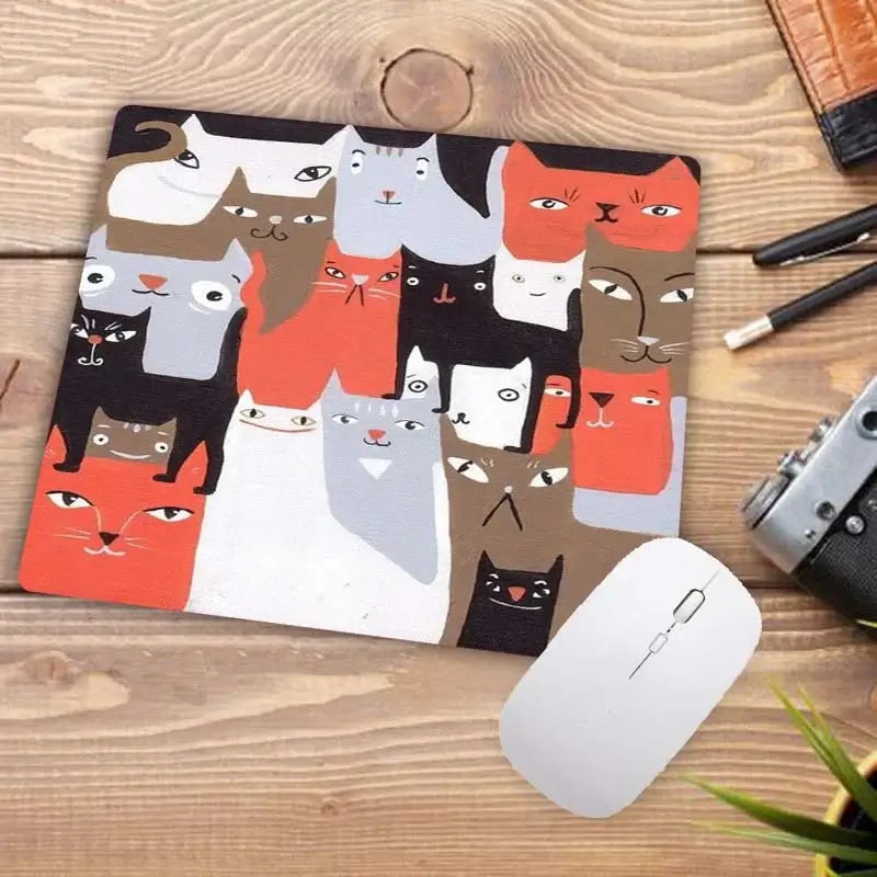 Cute Cat Mousepad with abstract cartoon cat faces in warm tones. Unique and artistic design for creative workspaces.