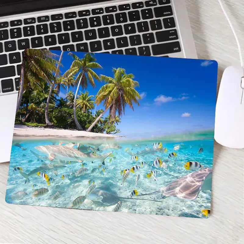 Custom gaming mouse pad with tropical fish and palm beach scene. Vivid underwater and island imagery enhances gaming experience.
