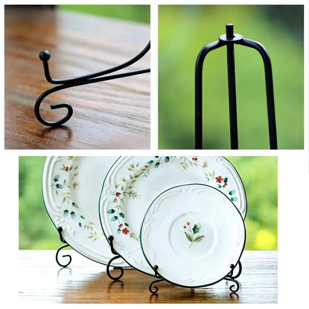 Close-up of black iron plate rack easel holding floral plates. Features elegant scroll feet and durable iron finish for decorative use.