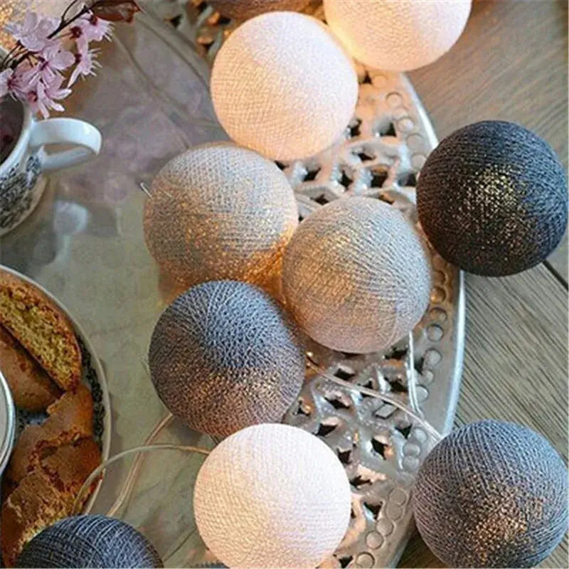Neutral-toned LED String Lights Cotton Balls in grey and white shades, enhancing cozy table decor with soft illumination.
