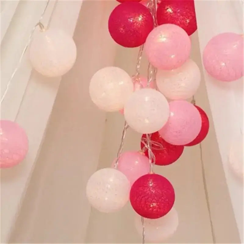 Red, pink, and white LED String Lights Cotton Balls draped on curtains, adding a romantic touch to any space.
