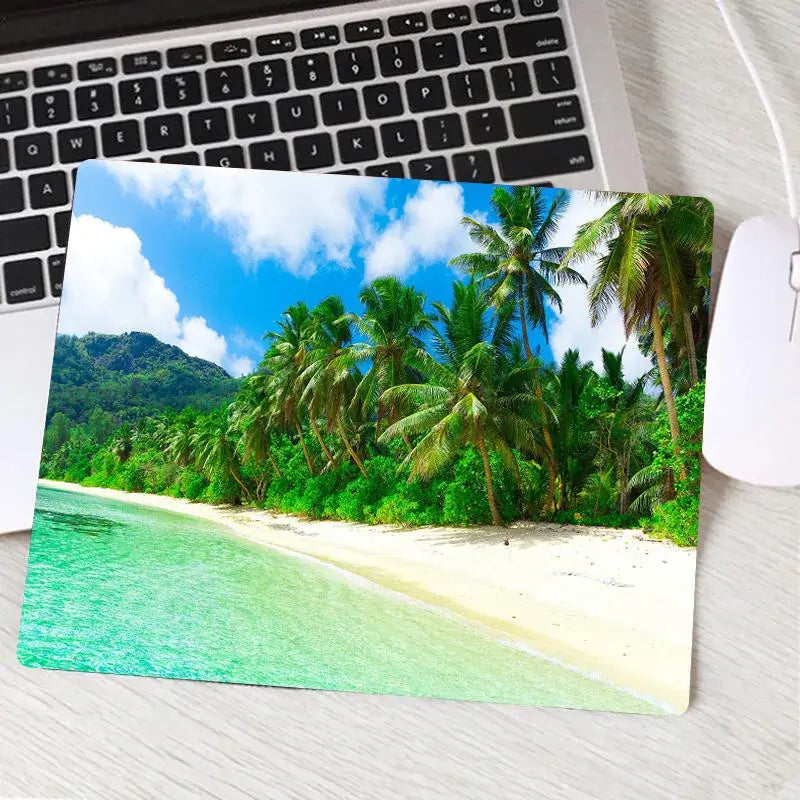 Gaming mouse pad with lush green palm trees and clear beach design. Custom tropical theme adds flair to any gaming or office setup.
