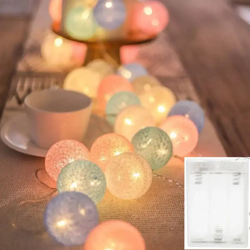 Warm LED String Lights Cotton Balls in soft hues on a table setting, USB/Battery powered for versatile indoor decoration.