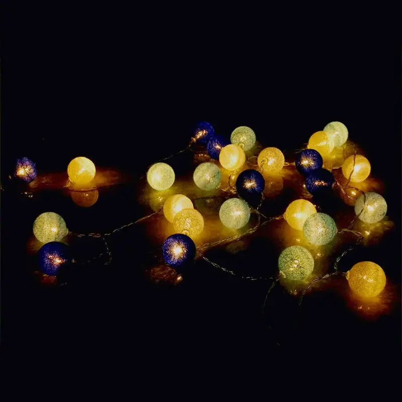 Yellow, green, and blue LED String Lights Cotton Balls glowing in the dark, perfect for ambient garden or indoor lighting.