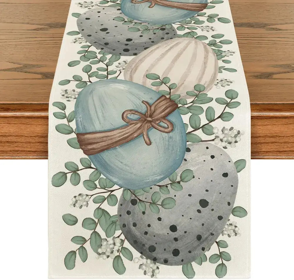 Eucalyptus Easter Table Runner - Linen featuring painted eggs and greenery on a wooden table. Ideal for spring and Easter dining decor.