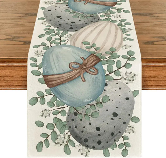 Eucalyptus Easter Table Runner - Linen featuring painted eggs and greenery on a wooden table. Ideal for spring and Easter dining decor.