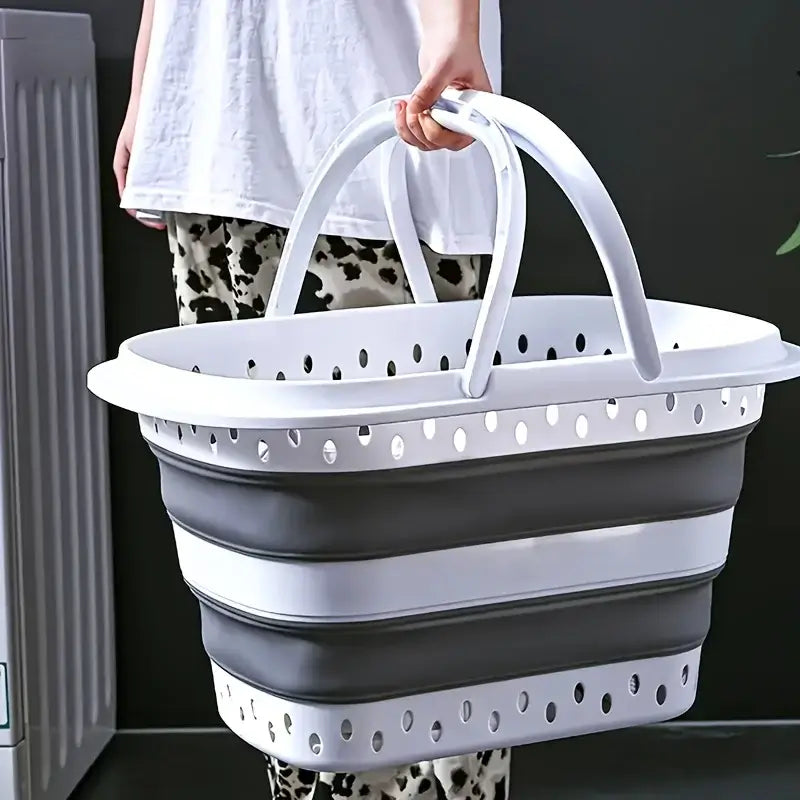 Foldable laundry basket with large capacity and dual handles, shown being carried for easy portability in home laundry use.