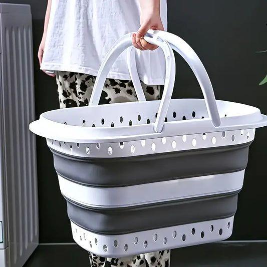 Foldable laundry basket with large capacity and dual handles, shown being carried for easy portability in home laundry use.