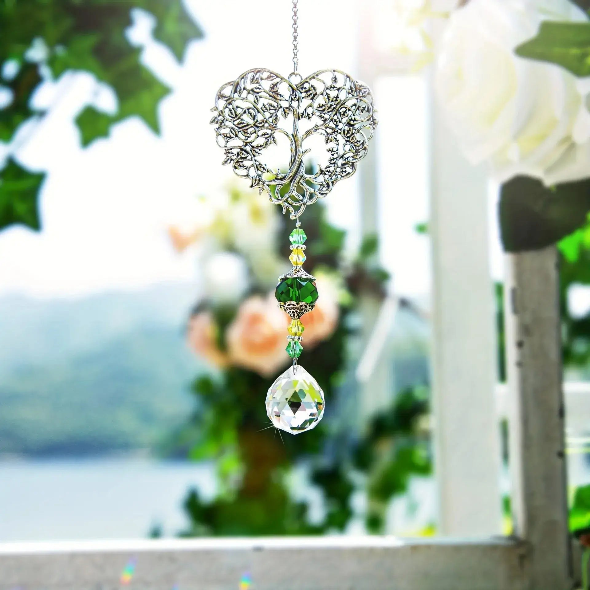 Tree of Life Suncatcher - Crystal Pendant displayed in a romantic outdoor setting, reflecting sunlight beautifully for garden decor.