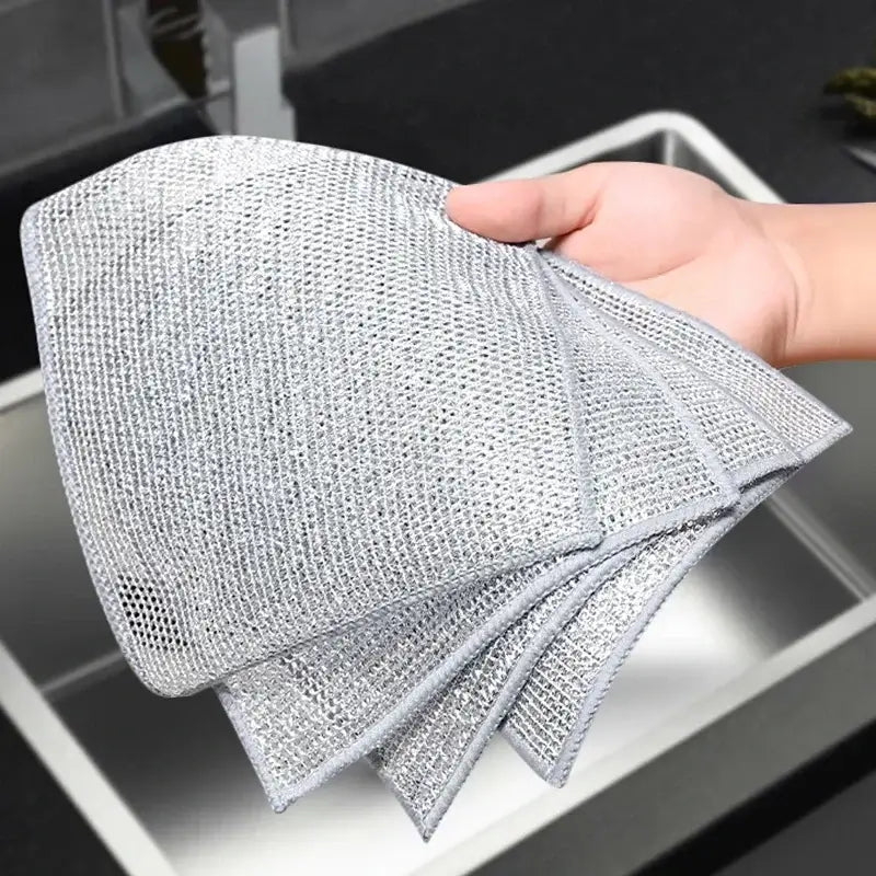 Hand holding multiple Magic Dishcloth Silver Wire cloths, showcasing flexible and durable texture for effective kitchen cleaning.