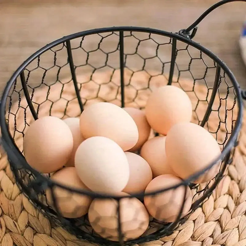 Top view of metal wire egg basket with fresh eggs inside. Perfect for rustic kitchen decor and egg organization.