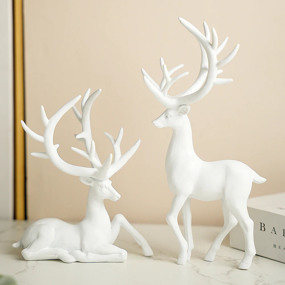 Elk Ornaments Set in white resin with a matte finish. Includes standing and sitting elk figurines for modern holiday home décor.