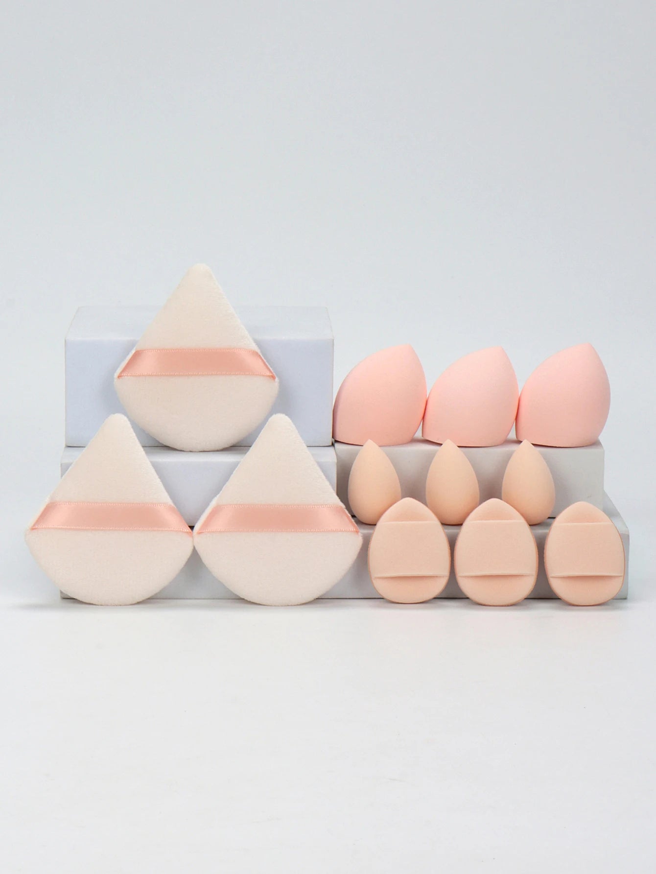 Blush pink 12-piece makeup sponge set with soft puffs and blending sponges. Designed for flawless foundation and contouring.