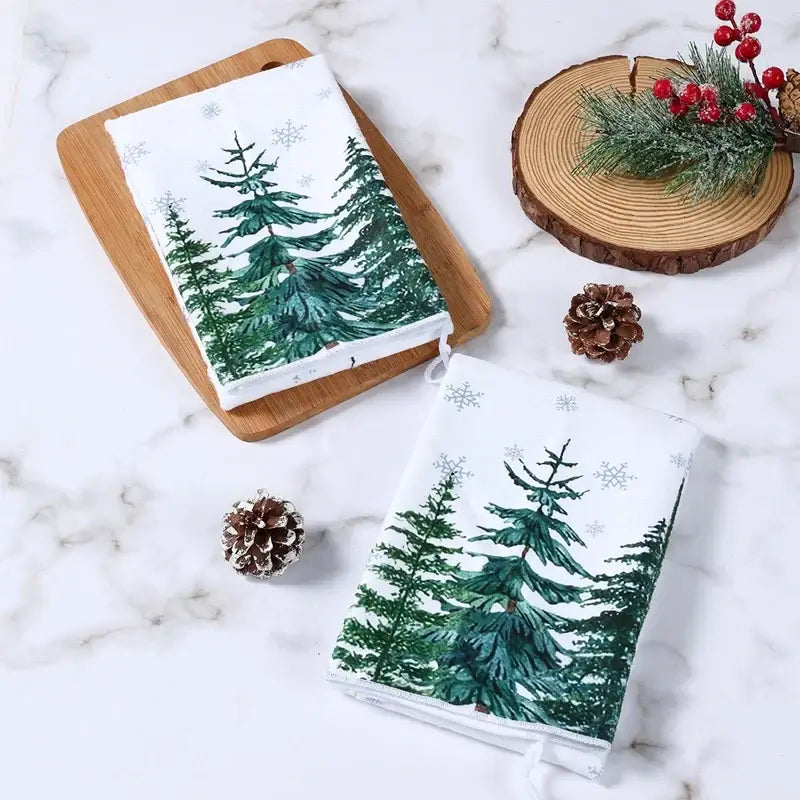 Christmas kitchen towels with green trees and snowflake pattern. Cotton towels ideal for festive kitchen drying and decor.