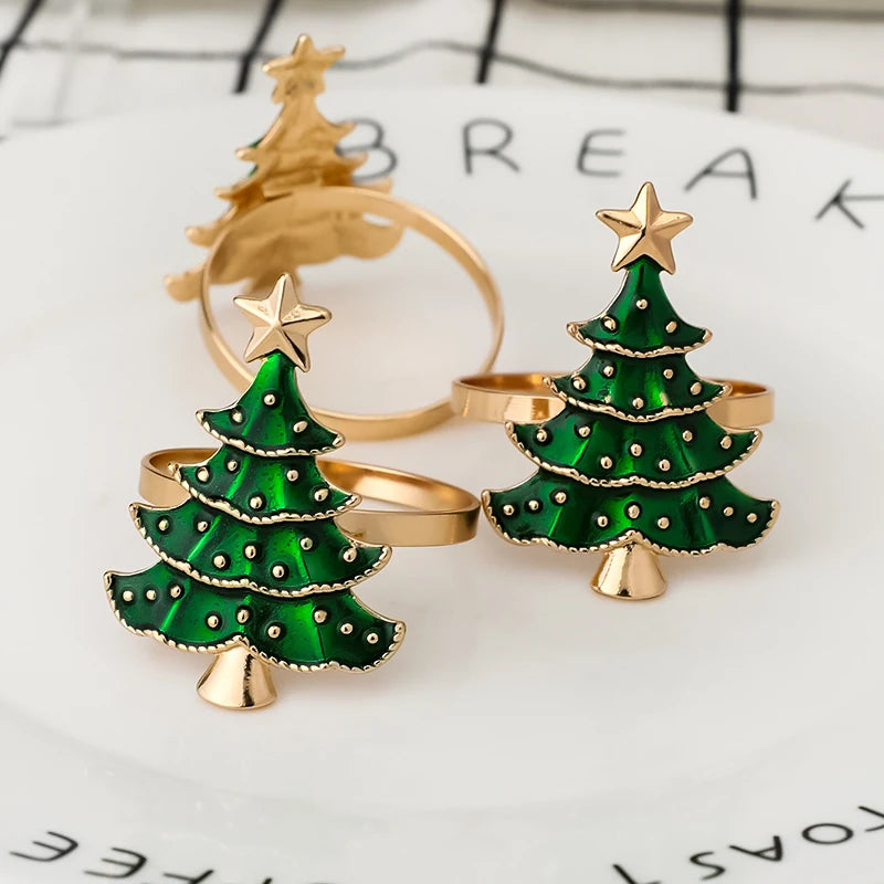 Close-up of Christmas tree napkin rings with gold band and green tree design, perfect for enhancing holiday table settings.