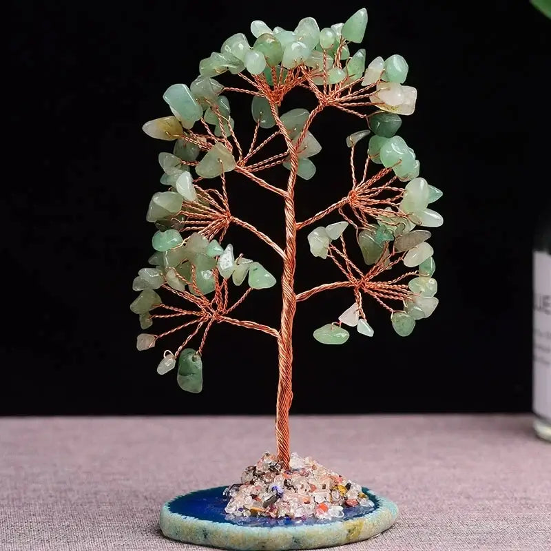 Green aventurine crystal money tree with copper wire branches on a blue agate base. Symbolizes prosperity and harmony in home decor.