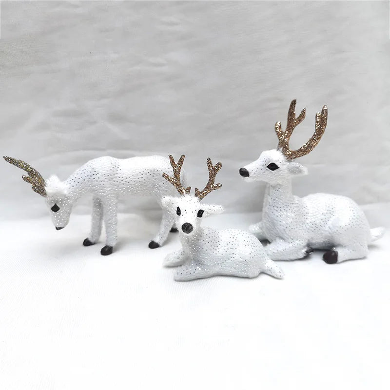 Three white Deer Reindeer Figurines - Table Miniatures with glitter and gold antlers, designed for elegant Christmas displays.