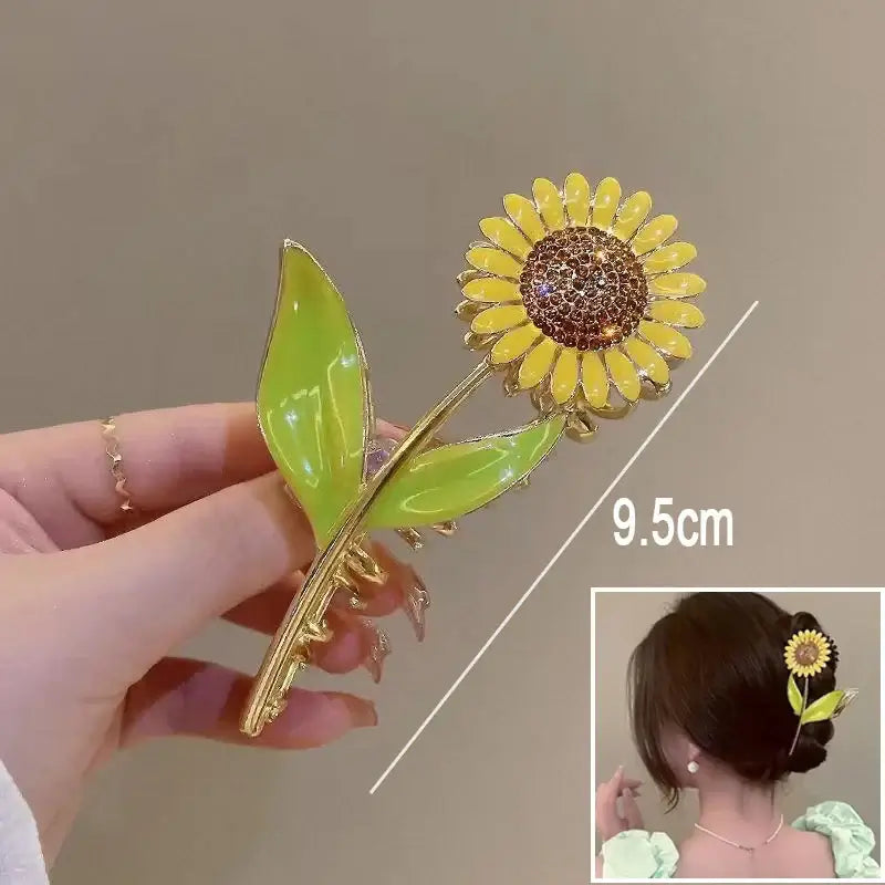 Sunflower ponytail hair clip with green leaves, 9.5cm long, designed for strong grip and vibrant floral style.