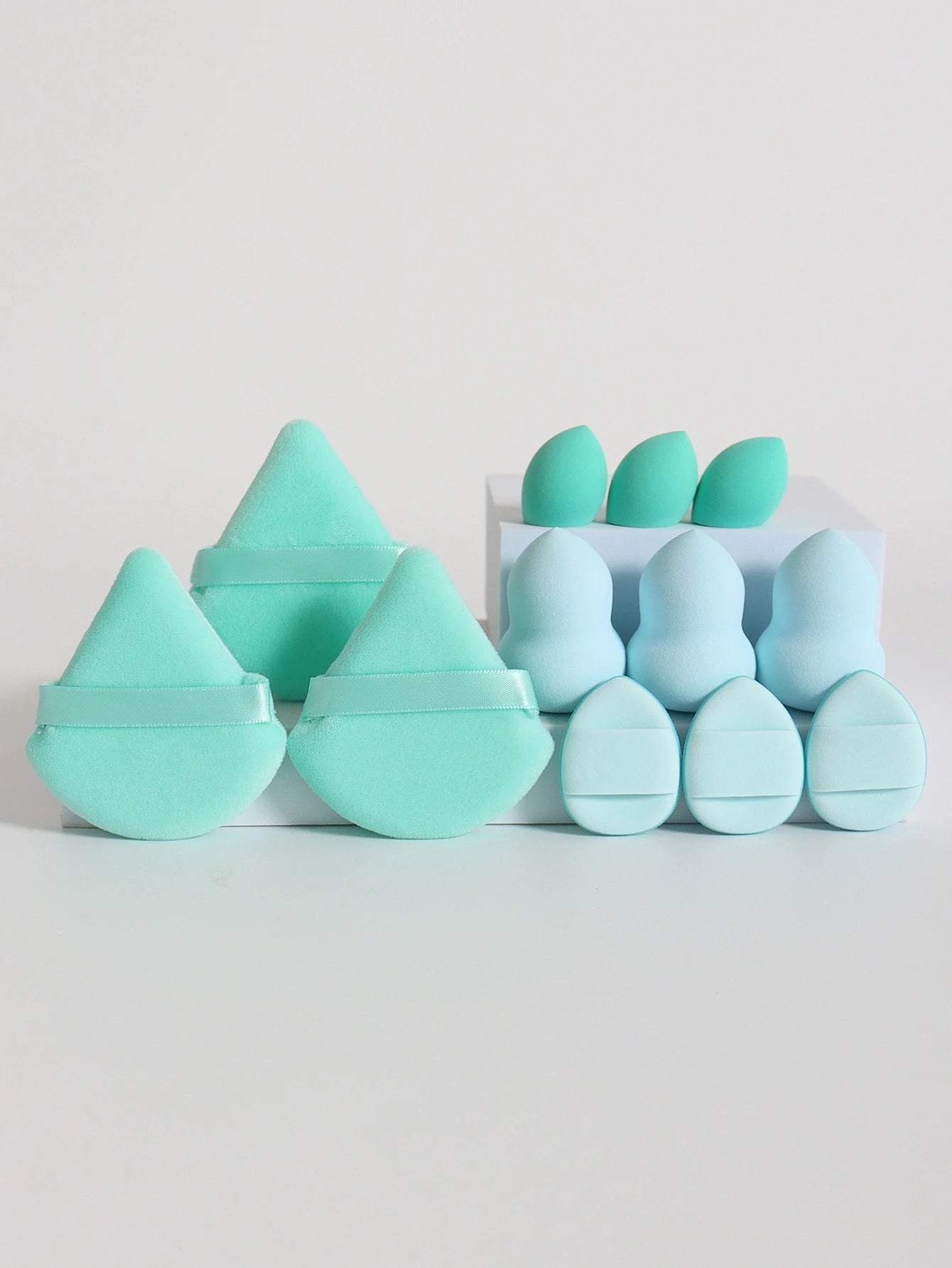 Mint and aqua 12-piece makeup sponge set with various sponge shapes and puffs. Ideal for all-purpose makeup blending and contouring.