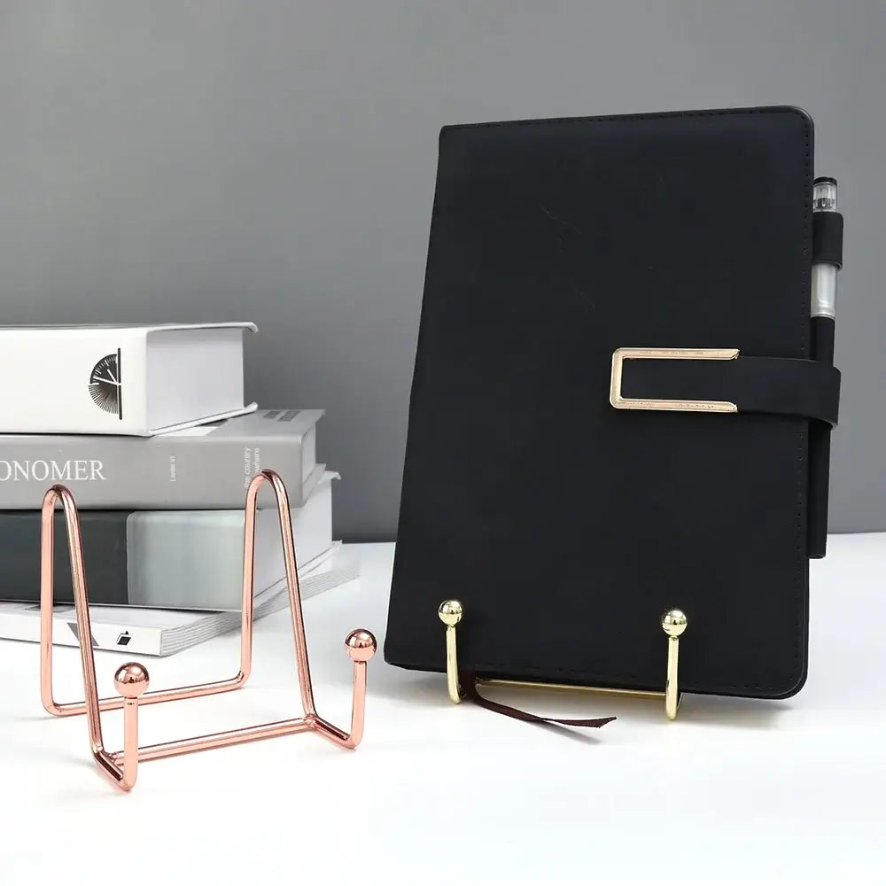 Versatile art display frame stand holding a black notebook on a desk. Perfect for showcasing books or frames elegantly.