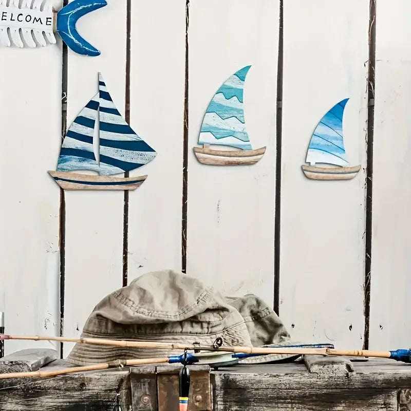 Wooden Sailboat Wall Art Set on rustic white wood panels with fishing gear. Great for cabin or lake house decoration.