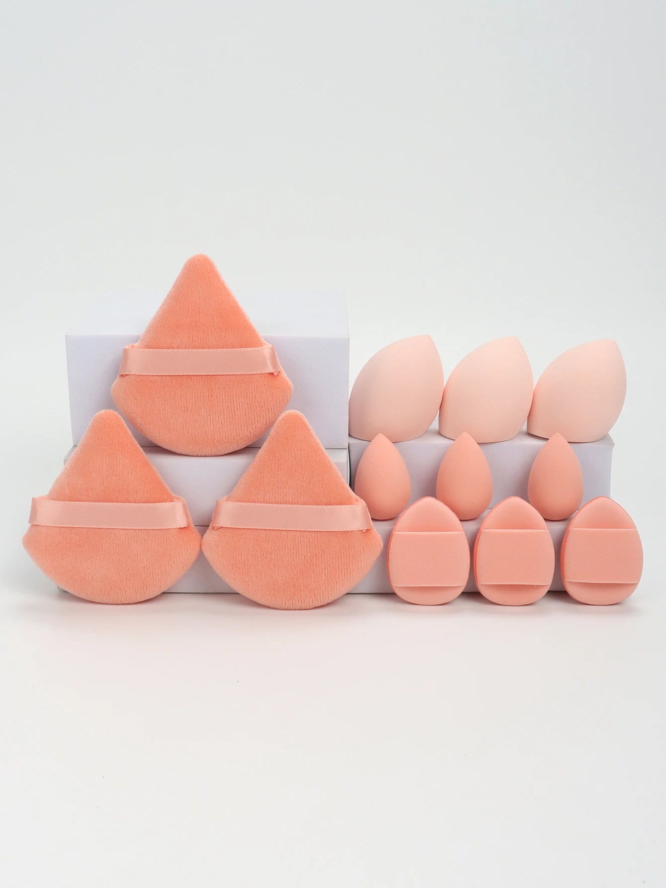 Coral orange 12-piece makeup sponge set with soft puffs and blending sponges. Great for flawless foundation and contouring.