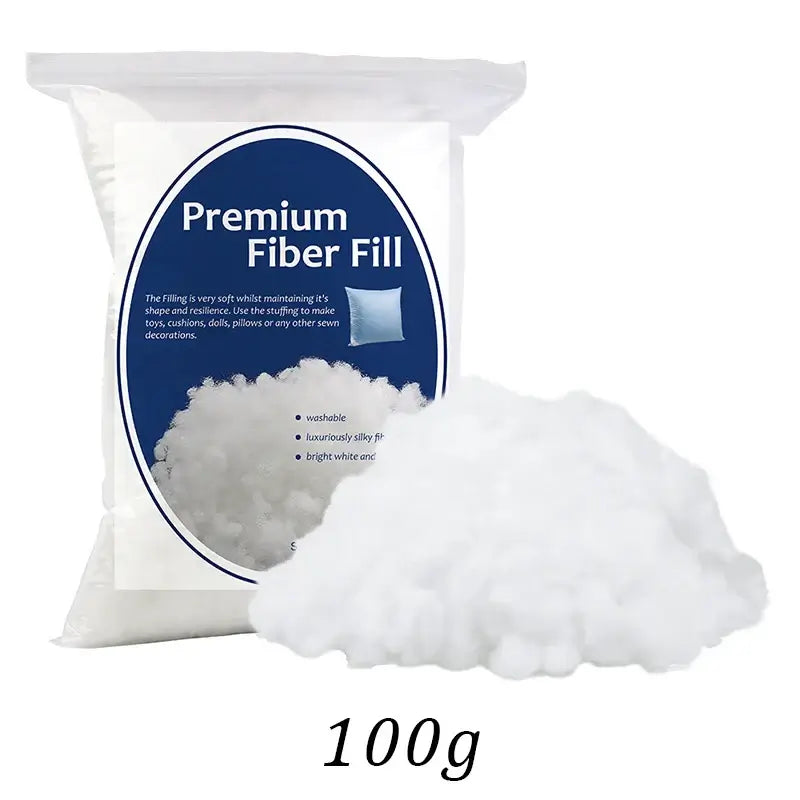 100g bag of KRABALL Premium Fiber Fill with fluffy stuffing shown. Washable and silky fiber for pillows and crafts.