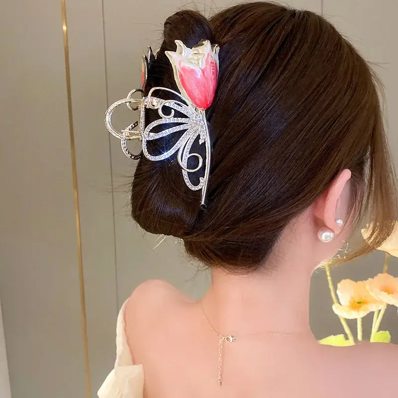 Pink tulip ponytail hair clip with butterfly-shaped metal design, perfect for elegant updos and secure hair styling.