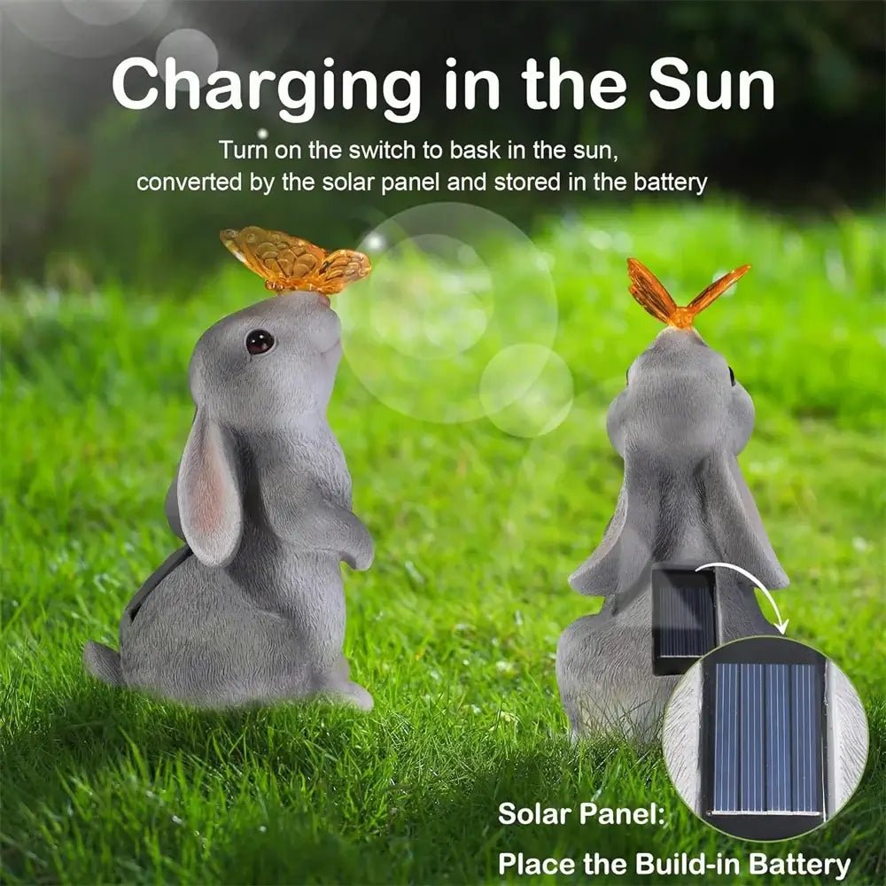 Solar Bunny Garden Decor charging in sunlight with built-in solar panel. LED light feature stores energy for nighttime illumination.