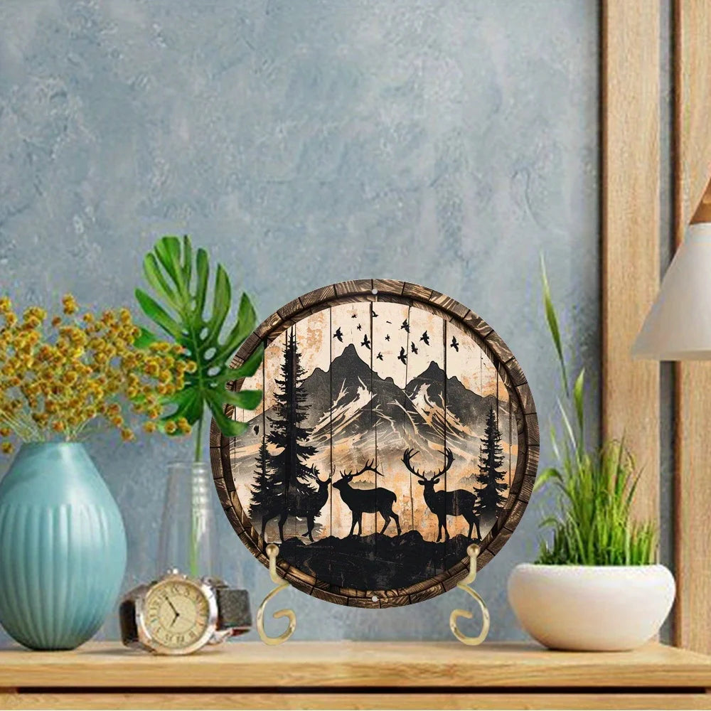 Wildlife metal art deer sign displayed on a table in a modern room. Features elk and buck design with rustic mountain scene.