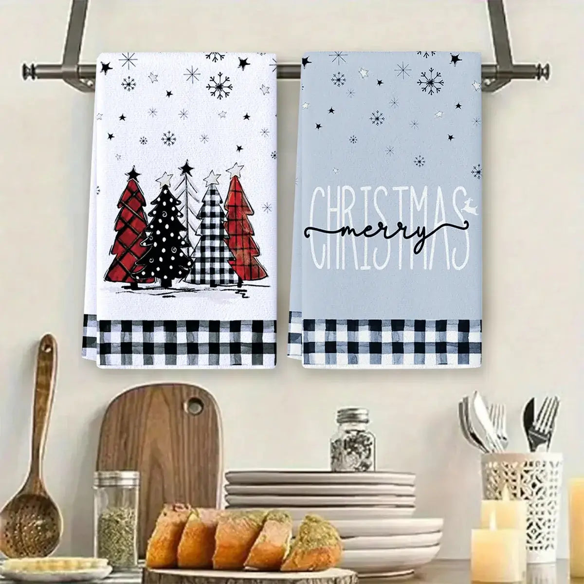 Set of two Christmas kitchen towels with plaid trees and 'Merry Christmas' text. Soft cotton towels perfect for festive kitchen use.
