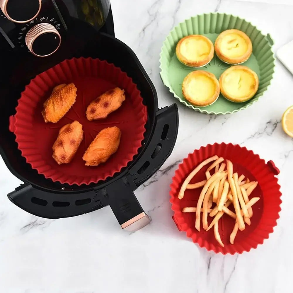 Red and green silicone air fryer liners pot used for cooking fries, wings, and tarts. Heat-resistant and dishwasher safe for convenience.