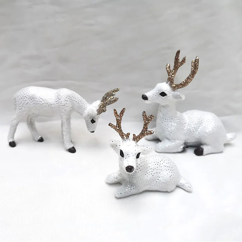 Sparkling white Deer Reindeer Figurines - Table Miniatures trio with golden antlers, ideal for holiday or winter-themed decor.