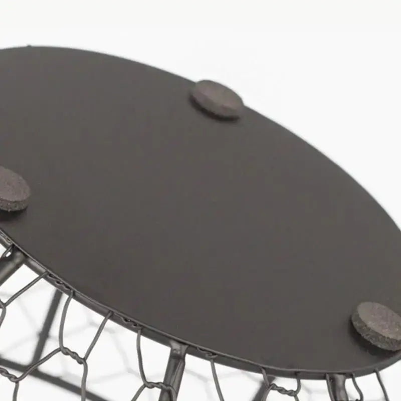 Close-up of non-slip base on metal wire egg basket. Features anti-slip pads for stable placement on kitchen surfaces.