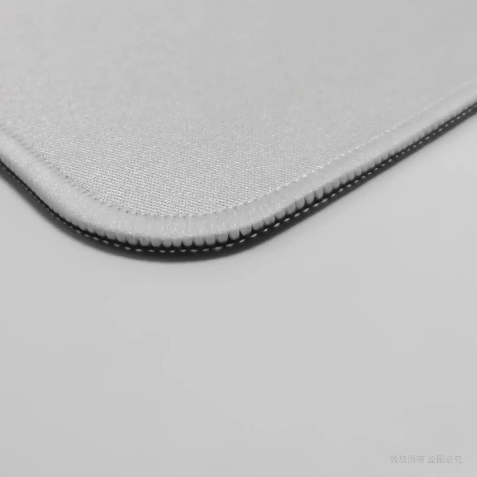 Close-up of custom gaming mouse pad edge stitching and smooth surface. Durable design ensures long-lasting precision and comfort.