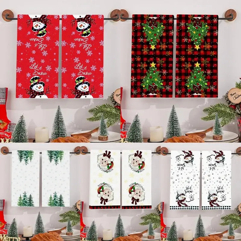 Stacked Christmas kitchen towels with various holiday designs including Santa, trees, and snowmen. Quick-dry cotton for festive kitchens.