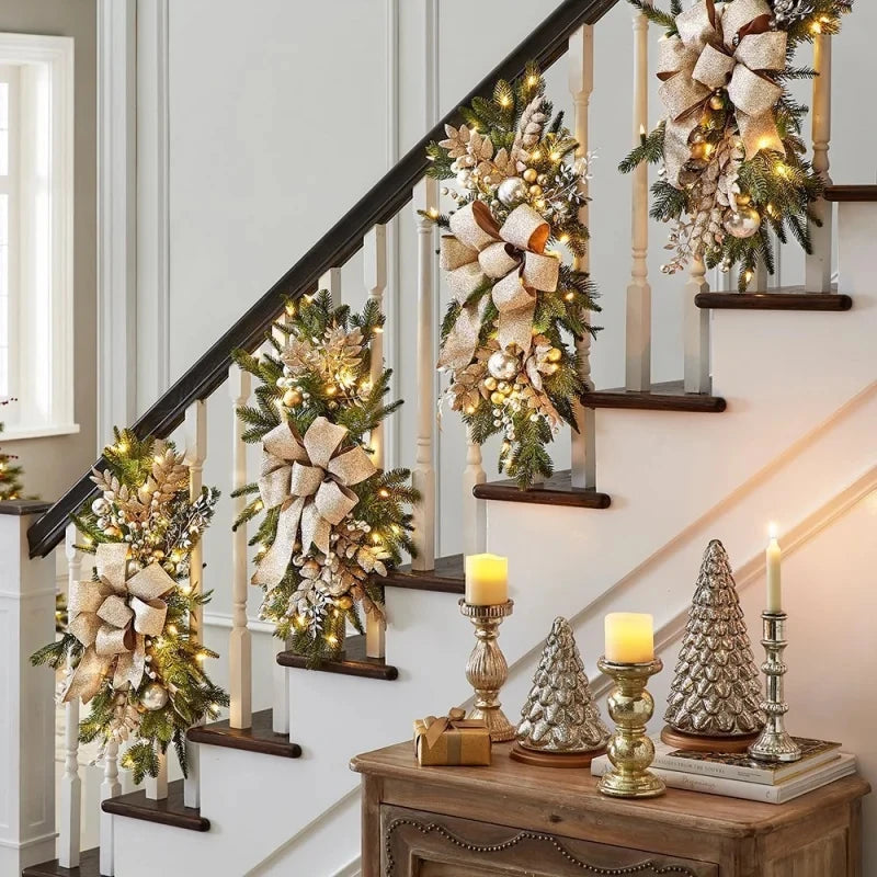 Gold Christmas Stair Wreaths with lights and metallic accents on staircase. Luxurious holiday garland decor for festive home ambiance.