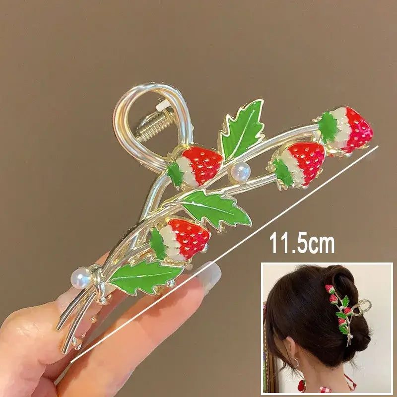 Strawberry ponytail hair clip with red berries and green leaves, 11.5cm long, ideal for secure and playful hairstyles.