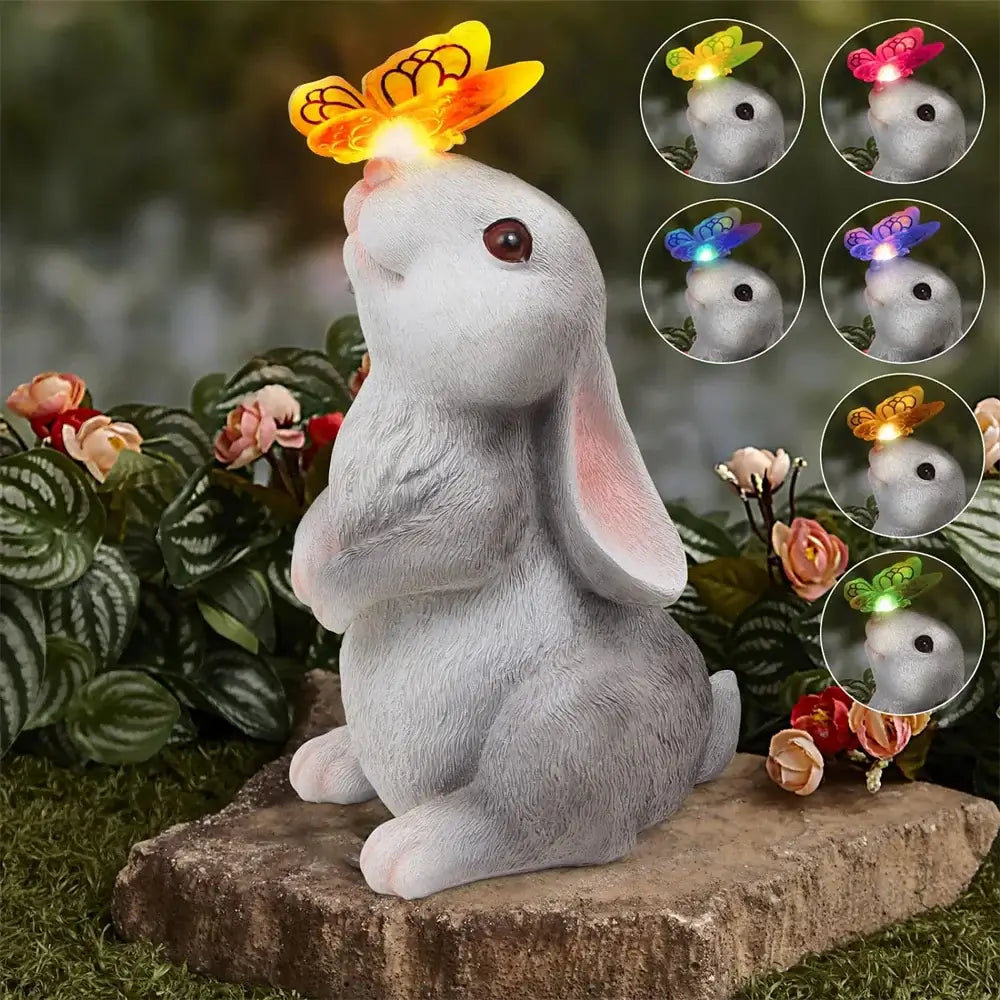 LED Solar Bunny Garden Sculpture with color-changing butterfly light. Resin decor perfect for lawns, flower beds, or outdoor landscaping.