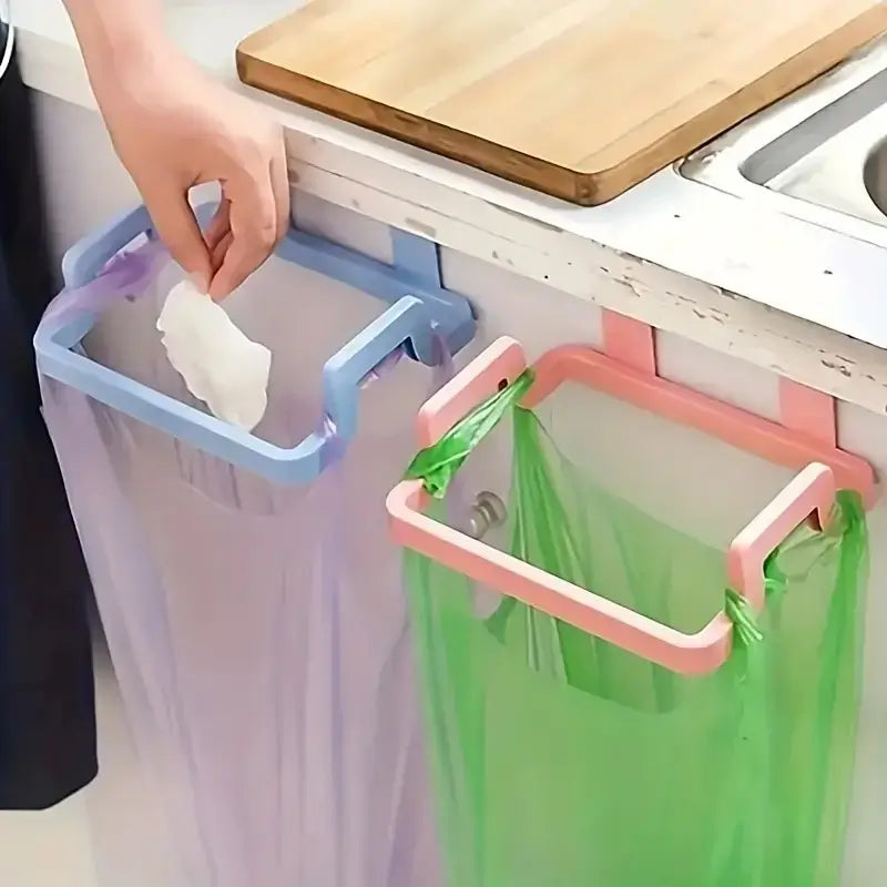 Multi-color under sink trash bag hooks mounted on cabinet doors for hands-free waste disposal. No-drill design ideal for kitchen or bathroom use.