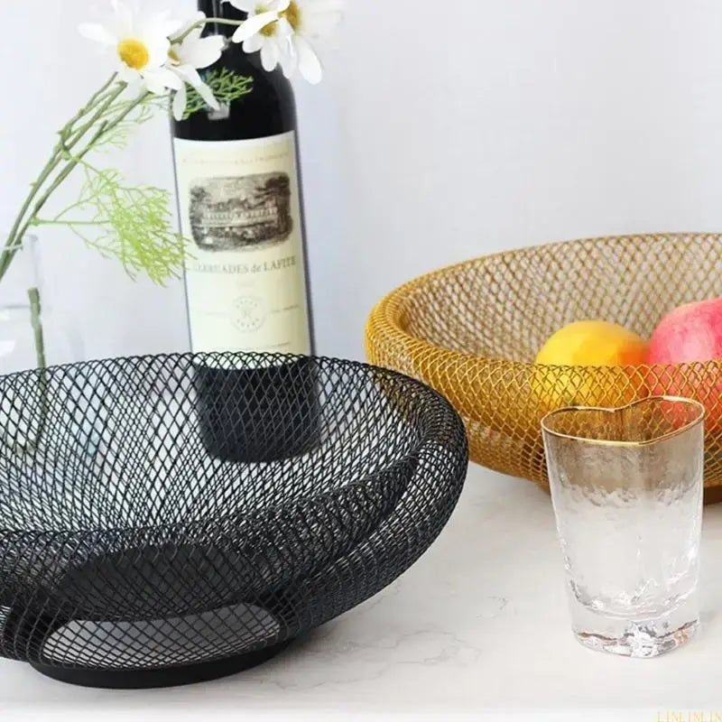 Black and gold metal fruit baskets on a kitchen counter, highlighting their large capacity and eco-friendly painted finish.