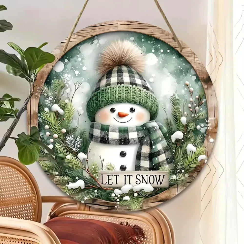 Snowman Sign - Wooden Circular Art | 20x20cm Design shown hanging near a window, enhancing cozy holiday ambiance with festive greenery and snowflakes.