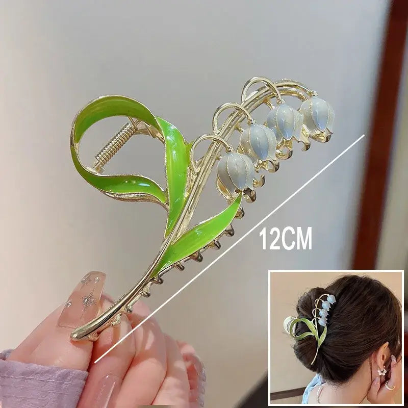 White bell flower ponytail hair clip with green stem, 12cm long, designed for secure hold and elegant floral styling.