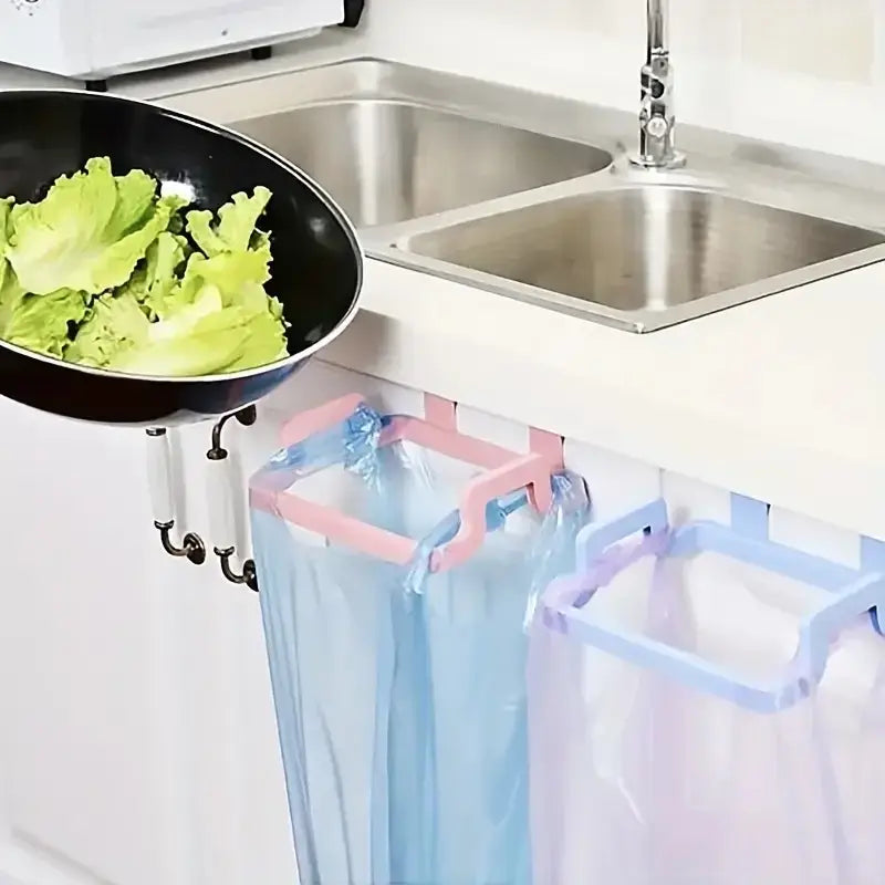 Under sink trash bag hooks in pastel colors used for disposing lettuce. No-drill cabinet door hooks for efficient kitchen waste handling.