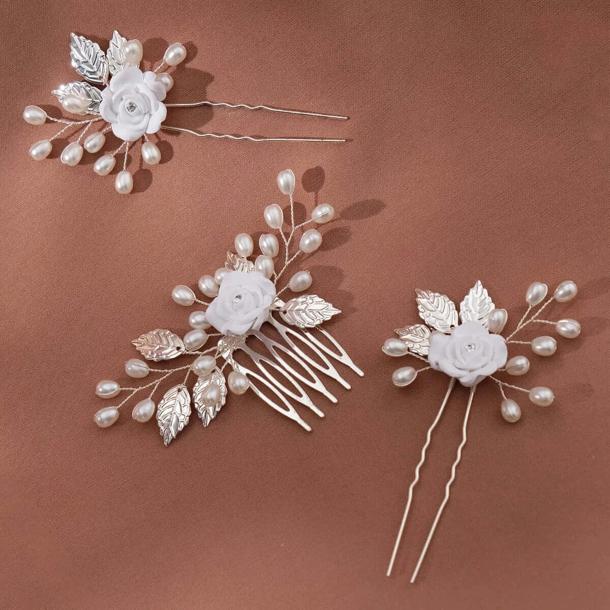 Detailed view of white 3PK Flower Hair Pin Set featuring polymer clay roses, silver leaves, and pearl accents for elegant hair styling.