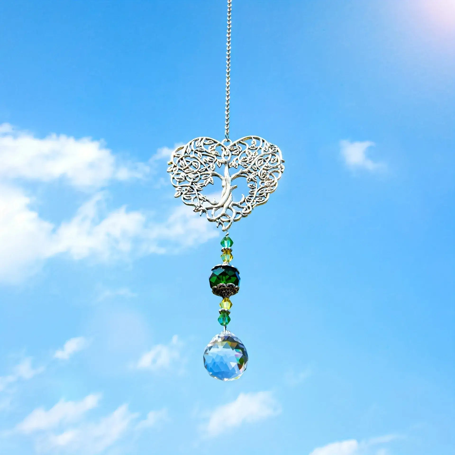 Tree of Life Suncatcher - Crystal Pendant sparkling against a clear blue sky, perfect for enhancing natural light in home or garden.