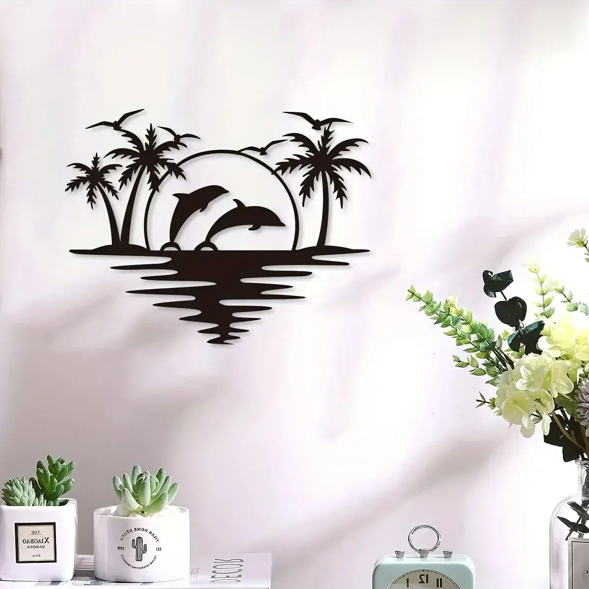 Dolphin Coconut Tree Hook - Indoor Outdoor Decor displayed above a white shelf with plants, perfect for beach-style home and garden accents.