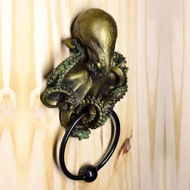 Side view of octopus skull resin door knocker on wooden surface, showcasing detailed tentacles and antique bronze finish with black iron ring.