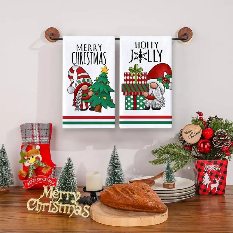 Folded Christmas kitchen towels with green pine tree design. Soft cotton towels perfect for winter kitchen decor.