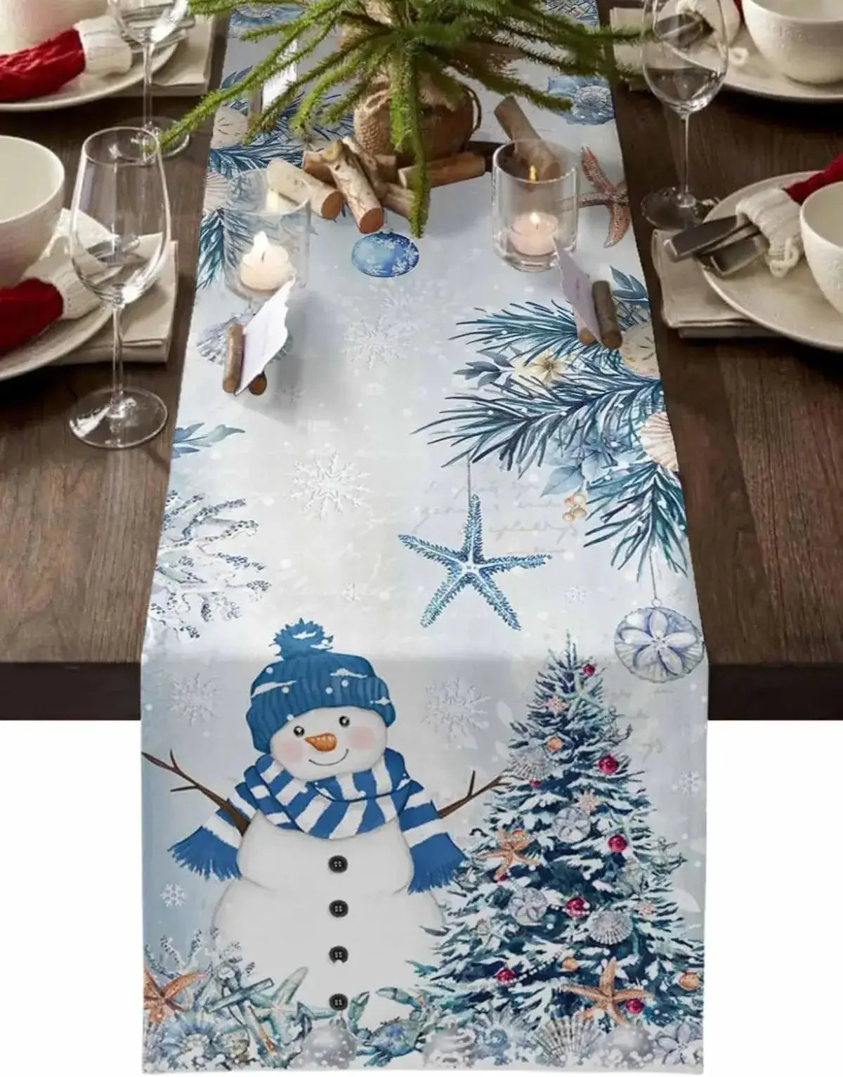 Blue Christmas linen table runner with snowman, tree, and starfish accents. Winter holiday decor for festive dining and seasonal gatherings.